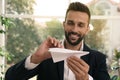 Handsome businessman playing with paper plane in office Royalty Free Stock Photo
