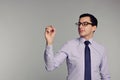 Handsome businessman in shirt,tie, glasses holding pen. Writ