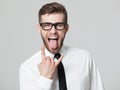 Handsome businessman showing goat gesture and his tongue isolate Royalty Free Stock Photo