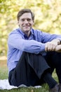 Handsome businessman sitting on lawn Royalty Free Stock Photo