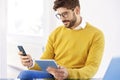 Handsome businessman sitting in the office and using cell phone Royalty Free Stock Photo