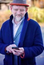 Handsome businessman standing outside and looking at his phone Royalty Free Stock Photo