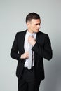 Handsome businessman straightening his tie Royalty Free Stock Photo