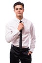 Handsome businessman straightening his tie Royalty Free Stock Photo