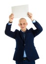 Handsome businessman in stylish suit holding empty sheet of paper over his head isolated on white background Royalty Free Stock Photo
