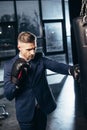 handsome businessman in suit boxing