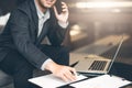 Handsome businessman in suit and eyeglasses speaking on the phone in office,Side view shot of a man`s hands using smart phone in r Royalty Free Stock Photo