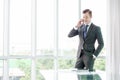 Handsome businessman in suit speaking on the phone