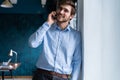 Handsome businessman in suit standing and talking on smartphone Royalty Free Stock Photo