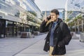 A handsome businessman is talking on the cell phone near his office. Copy space Royalty Free Stock Photo