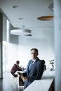 Handsome businessman using his tablet in the office Royalty Free Stock Photo