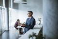 Handsome businessman using his tablet in the office Royalty Free Stock Photo