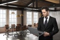 Handsome businessman using laptop in meeting room Royalty Free Stock Photo