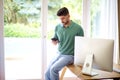 Handsome businessman using mobile phone and text messaging in the office Royalty Free Stock Photo