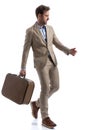 Handsome businessman walking with his briefcase and looking away Royalty Free Stock Photo
