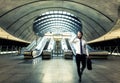 Handsome businessman walking and talking with her smart phone