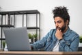 Handsome businessman wearing casual wear is sitting typing on la Royalty Free Stock Photo