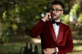 Handsome businessman wearing red tuxedo talking on the phone astonished Royalty Free Stock Photo