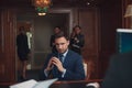 Handsome businessman wearing suit in Hotel check in at reception or front office being Royalty Free Stock Photo