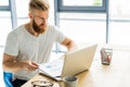 Handsome businessman working with laptop in office. Royalty Free Stock Photo