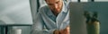 Focused male freelancer making notes during working on laptop sitiing desk in coworking Royalty Free Stock Photo