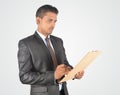 Handsome businessman writing on clipboard, isolated very profess Royalty Free Stock Photo