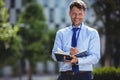 Handsome businessman writing in dairy