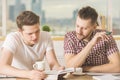 Handsome businessmen reading book and doing paperwork Royalty Free Stock Photo