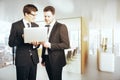 Handsome businessmen using laptop together Royalty Free Stock Photo