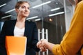 Handsome businesswomen handshaking after succsessful deal Royalty Free Stock Photo