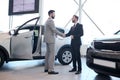 Handsome Car Salesman Shaking Hands with Client Royalty Free Stock Photo