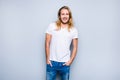 Handsome careless smiling young guy with long blonde hair, cloth Royalty Free Stock Photo