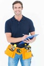 Handsome carpenter writing on clipboard