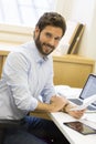 Handsome casual business man working on computer in modern offic Royalty Free Stock Photo