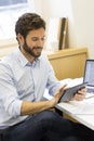 Handsome casual business man working on computer in modern offic