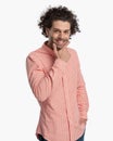 handsome casual guy with curly hair touching chin and wondering Royalty Free Stock Photo