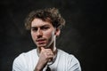 Handsome and casual-looking man posing for the photoshoot on the dark background