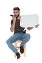 Handsome casual man talking at phone, holding speech bubble Royalty Free Stock Photo