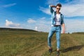 Handsome casual man fixes his hair in a field outside Royalty Free Stock Photo