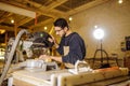 Handsome caucasian carpenter man work using machine for wood cutting Royalty Free Stock Photo