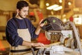 Handsome caucasian carpenter man work using machine for wood cutting Royalty Free Stock Photo