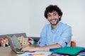 Handsome caucasian hipster working at home with computer