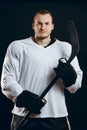 Handsome hockey player. Smiling at camera isolated on white