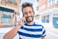 Handsome caucasian man with beard smiling happy outdoors speaking on the phone Royalty Free Stock Photo