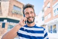 Handsome caucasian man with beard smiling happy outdoors speaking on the phone Royalty Free Stock Photo