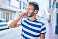 Handsome caucasian man with beard smiling happy outdoors speaking on the phone Royalty Free Stock Photo