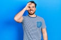 Handsome caucasian man with beard wearing casual striped t shirt doing ok gesture with hand smiling, eye looking through fingers Royalty Free Stock Photo