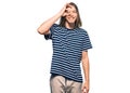 Handsome caucasian man with long hair wearing casual striped t-shirt doing ok gesture with hand smiling, eye looking through Royalty Free Stock Photo