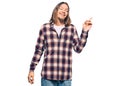 Handsome caucasian man with long hair wearing hipster shirt with a big smile on face, pointing with hand and finger to the side Royalty Free Stock Photo