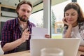 Handsome Caucasian man pointing with a pen on a copy space on the white blank paper sheet while talking by video call sitting at Royalty Free Stock Photo